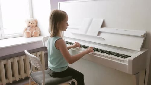 Girl Plays Piano in Sunny Room