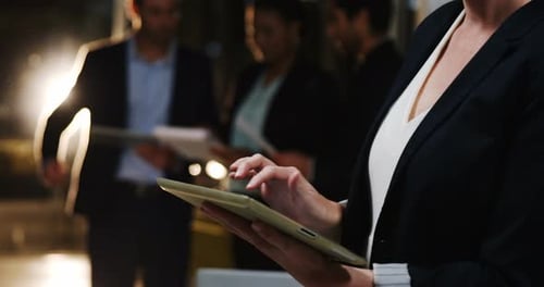 Office Team Using Tablets in Bright Environment