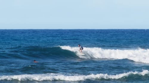 Surfer Riding and Turning with Spray on Blue Ocean Wave on Hawaii Island Coast