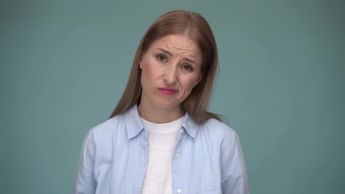 Distraught Woman with Headache Against Blue Background