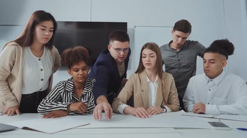 Diverse Team Collaborating on Project in Bright Office