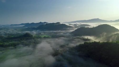 Flying through the clouds above the mountain peak.