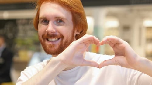 Man Makes Heart Shape With Hands