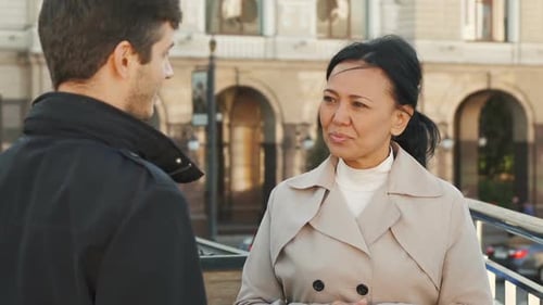 Smiling Woman Talking With Man in City