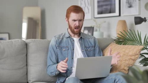 Frustrated Man Reacts to Laptop in Living Room