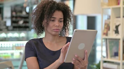Woman Reacts With Tablet Indoors