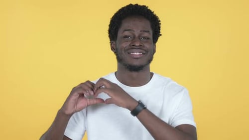 Young Adult Making Heart Shape With Hands