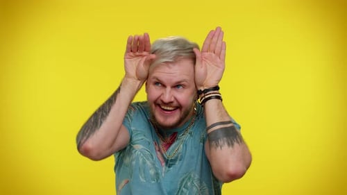 Lovely Funny Man Smiling Friendly Doing Bunny Ears Gesture on Head Having Fun Fooling Comical Mood