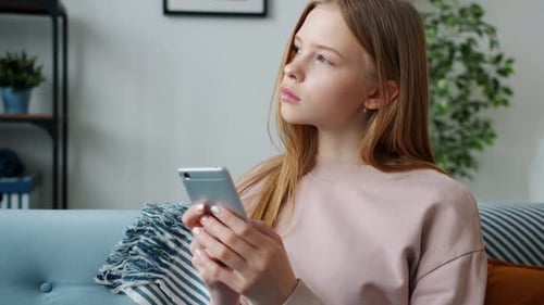 Teenager Uses Smartphone in Living Room