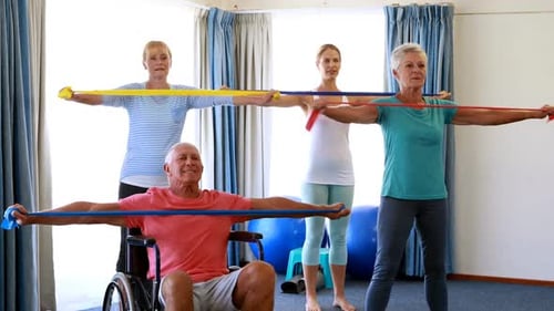 People Exercising Together with Resistance Bands Indoors
