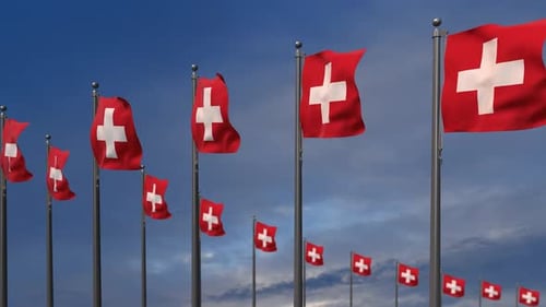 Waving Swiss Flags Against a Blue Sky Background