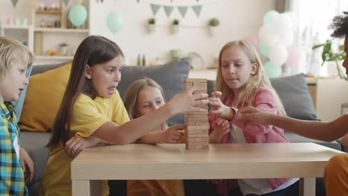 Friends Playing with Wooden Blocks Tower