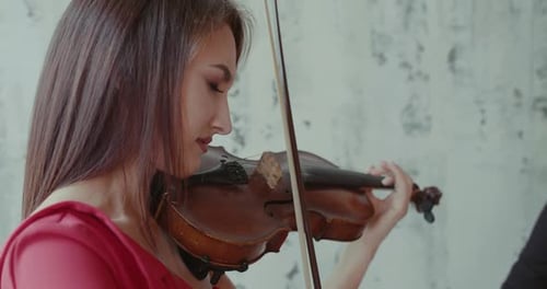 Young Woman Plays Violin with Grace and Focus