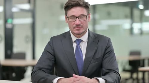 Man in Suit and Tie Looking at Camera