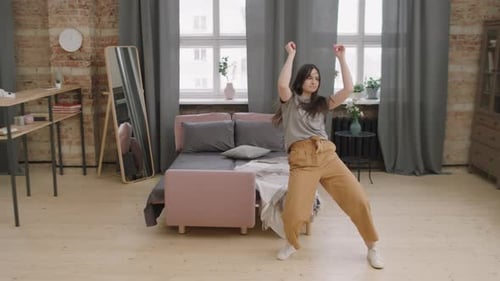 Young Adult Woman Dancing in Living Room