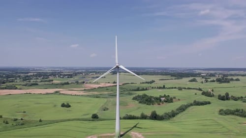 Aerial view of windmills farm for energy production on beautiful cloudy sky at highland. Wind power