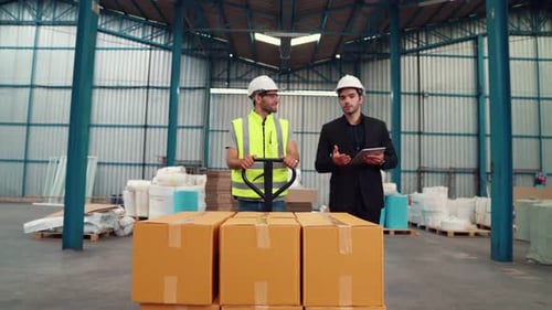Factory Workers Deliver Boxes Package on a Pushing Trolley in the Warehouse