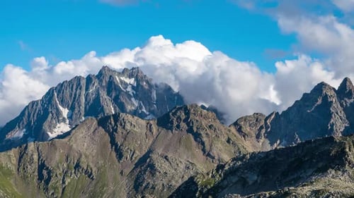 Puffy clouds over the mountains.