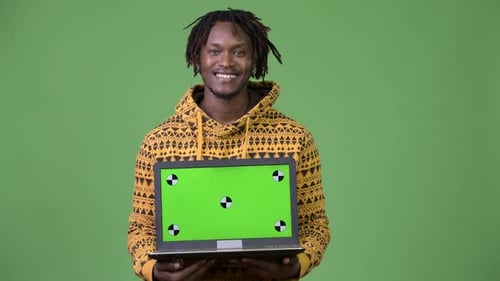 Smiling Man Holding Laptop with Green Screen