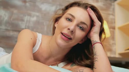 Woman Smiling Relaxed in Bed Close Up