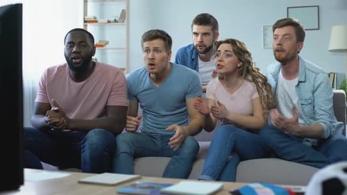 Excited Friends Cheering While Watching Sports Game