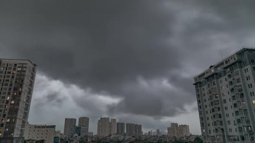 Heavy tropical rain storm over residential area with high rise buildings framing the sky time lapse.