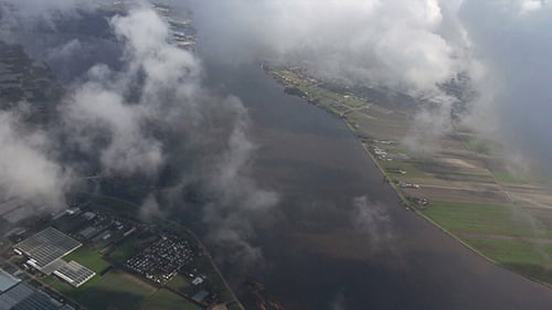 Airplane Flying Over City and Clouds 02
