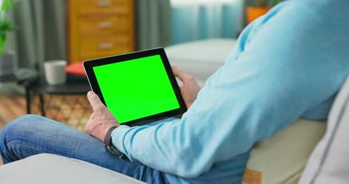 Close Up of Digital Tablet with Blank Green Mock Up Screen Display Hold By Old