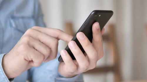 Hands Using Black Smartphone