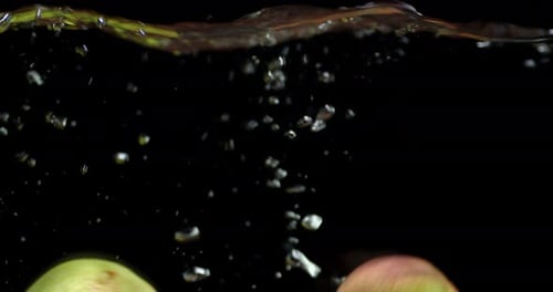 Pears Fall Under Water with Air Bubbles.