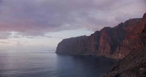 Amazing Ocean View of Los Gigantes Cliifs and Beach at Multicolor Purple Sunset Tenerife Canary
