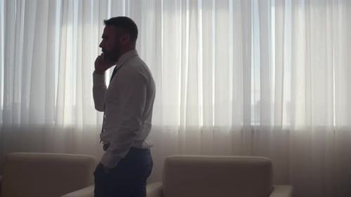 Professional Man Talking on Smartphone in Modern Office