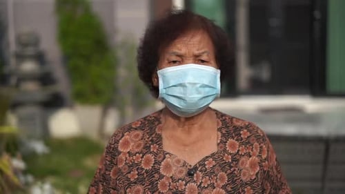 Senior Woman Wearing Surgical Mask Outside