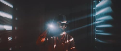 Man with Flashlight in Dark Urban Interior