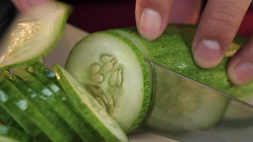 Knife Slicing A Cucumber
