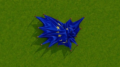 European Union Flag Unfurling on Green Grass
