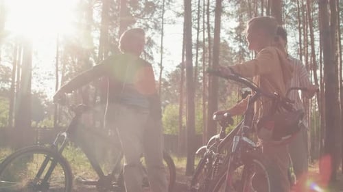 Family With Bikes Chatting In Woods