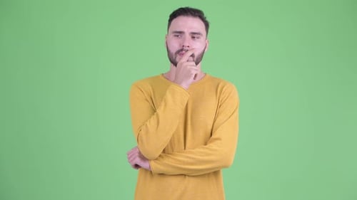 Stressed Young Bearded Man Thinking and Looking Down