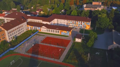 Courtyard of the School with Greenery and a Sports Ground for Basketball and Sports