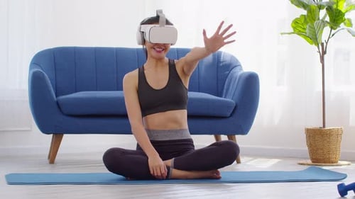 Woman in VR Headset Sits in Lotus Position