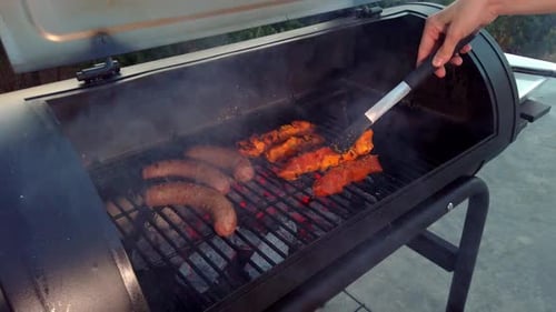 Checking the Meat on the BBQ. This summer there is nothing better to have with friends and family