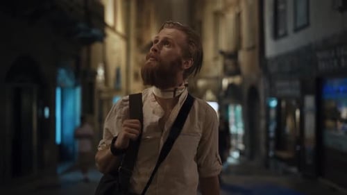 Close Up of Calm Millenial Hipster Guy with Vintage Camera Walking at Blured Old City Background