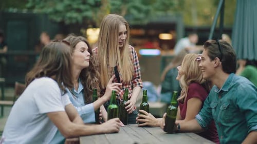 Friends Chatting and Laughing at Outdoor Table