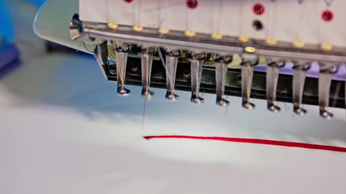 Embroidery Machine Stitching Red Line on White Fabric