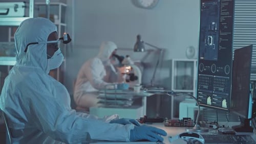 Scientists Working on Computers in Laboratory Setting