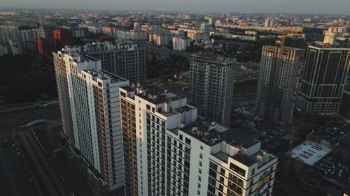 City block construction site. Multi-storey buildings. City landscape at sunrise. Aerial photography.