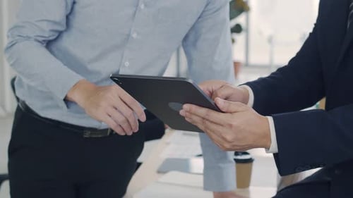 Close up businessman leader showing plan project to a creative employee in the modern office.