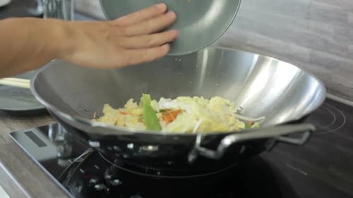 Stir Fry Cooking with Chopsticks in Kitchen