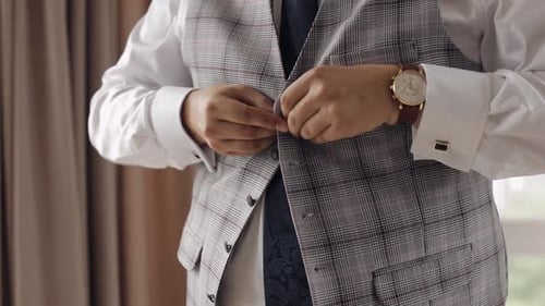 Buttoning Jacket with Hands Close Up Man in Suit Fastens Buttons on His Jacket Preparing to Go Out
