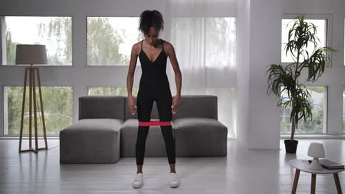 Woman Exercising at Home with Resistance Band